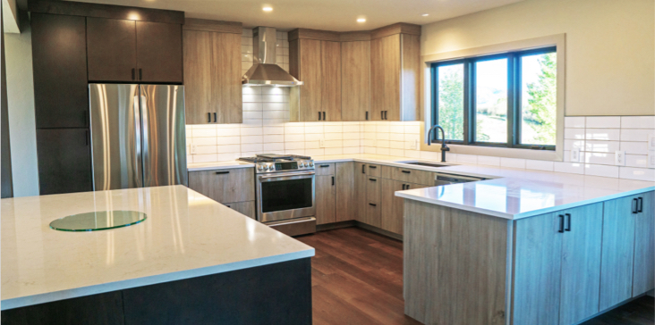 A kitchen with wooden cabinets and white counters.