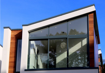 A building with two windows and a sky background