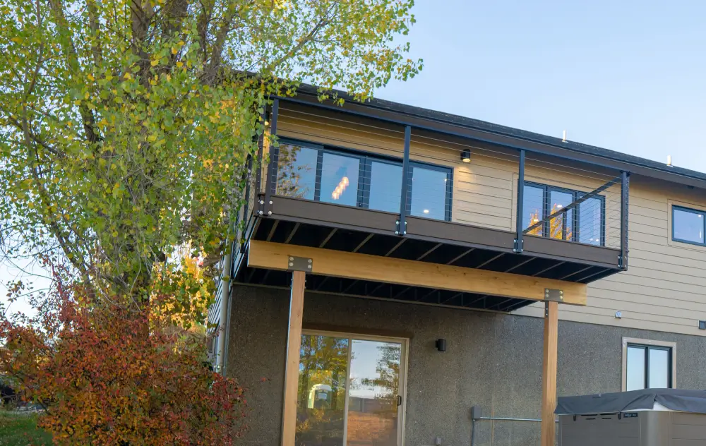 A building with a balcony and wooden railing.